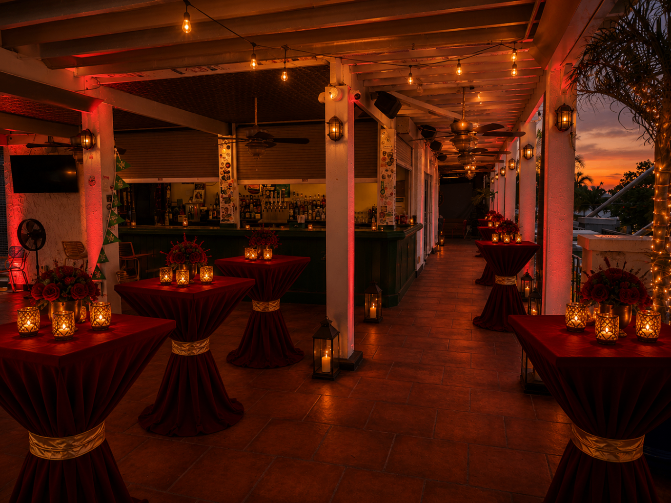 Long rooftop view of the Scarlett Soirée setup with glowing lanterns, string lights, and crimson tablescapes